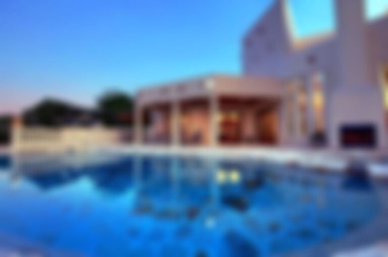 Features a custom designed, natural stone, negative edge pool.