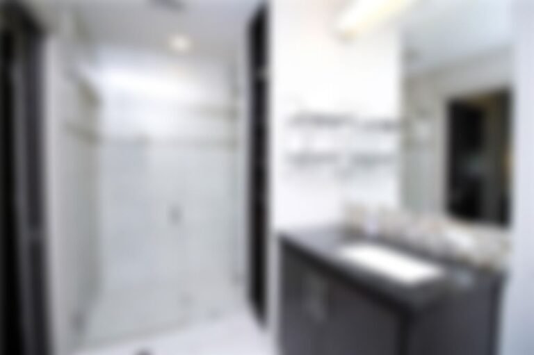 Roomy bathroom with walk-in, frameless glass shower.
